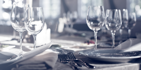 Restaurant table with tableware and table decoration