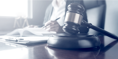 Judge's mallet on the desk of a lawyer working on a case