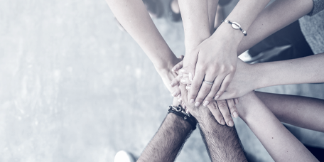 Members of a foundation putting their hands together, seen from above