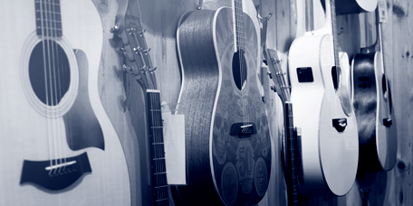 Different types of guitar for sale in a music shop