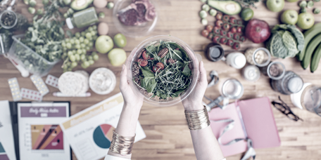 Food displayed on a table next to diet plans